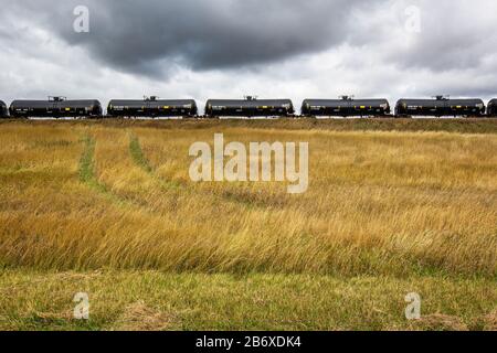 A freight train transporting oil from the Bakken field near Williston in North Dakota. The area is part of the Bakken oil field, where fracking technology has made it profitable as long as the oil price stays above USD 46 per barrel. Stock Photo