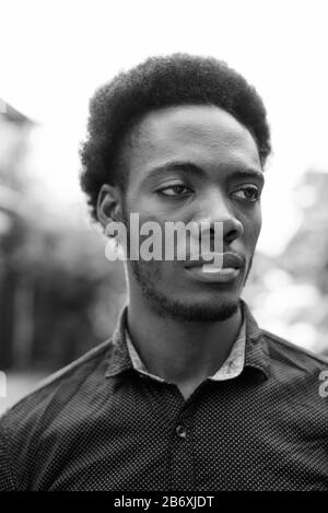 Young handsome man with afro hair sticking tongue out happy with funny ...