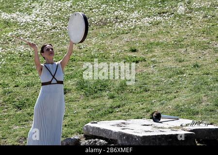 Olympia, Greece. 12th Mar, 2020. An actress performs during the flame lighting ceremony for Tokyo 2020 Olympic Games in Olympia, Greece, March 12, 2020. Credit: Antonis Nikolopoulos/Xinhua/Alamy Live News Stock Photo