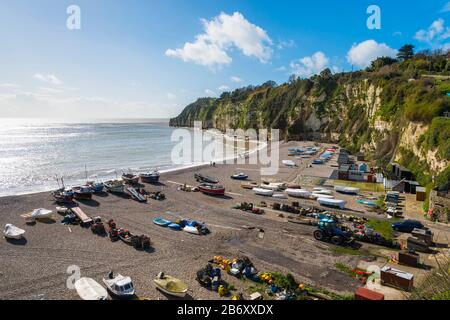 Beer, Devon, UK.  12th March 2020.  UK Weather.  View of the beach and fishing boats at the picturesque village of Beer in Devon on a day of warm spring sunshine and occasional showers.  Picture Credit: Graham Hunt/Alamy Live News Stock Photo