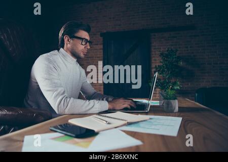 Profile side view of attractive intellectual financier analyst preparing finance presentation report plan strategy growth data analysis at industrial Stock Photo
