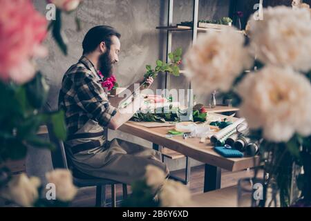 Profile side view photo of focused concentrated handsome person small business representative hold hand natural botanical offer order delivery sit Stock Photo
