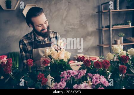 Portrait of cute handsome stylish trendy man freelancer environment vendor assistant touch rosebud rejoice excited feelings bunch bouquet dressed Stock Photo