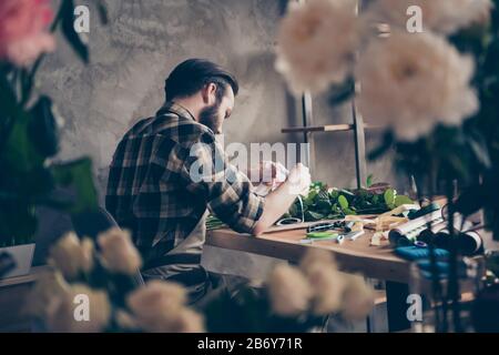 Profile side view photo of focused serious youth millennial hold hand diy variety small business representative masterclass sit table desktop wear Stock Photo