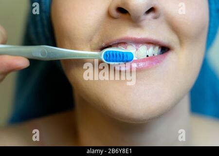 woman really washing her teeth after shower daily routine . Stock Photo