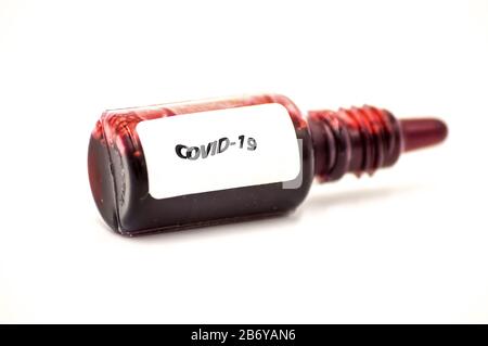 Covi19 Studio macro of a pharmacy flask filled with red liquid Stock Photo