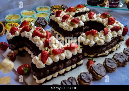 Mini candy bar with cupcakes and birthday cake with cream cheese Stock Photo