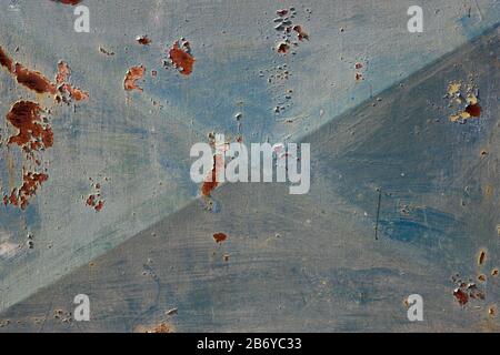 An old, rusty, colored plate with traces of background painting Stock Photo