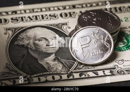 One Russian ruble lies on a one-dollar bill, close-up Stock Photo