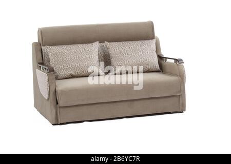 Wide view of light brown colored sofa with wooden resting arms and two pillows Stock Photo