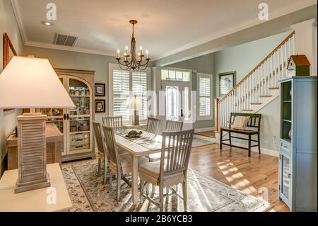 Beautiful open diningroom with light coming through door and windows. Stock Photo