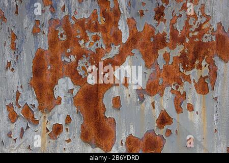 An old, rusty, colored plate with traces of background painting Stock Photo