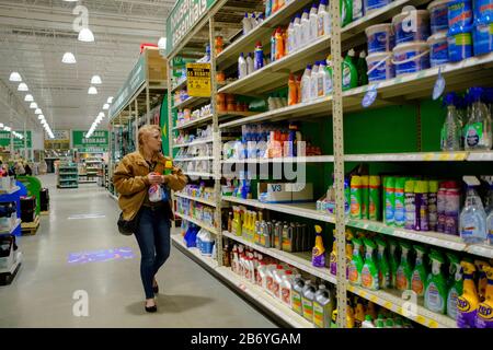 03112020 - Bloomington, Indiana, USA:  A woman shops for disinfectants at Menards on the day World Health Organization declared Coronavirus to be a pandemic. Toilet paper, wipes, protective breathing masks, and other items are either sold out at local stores, or are in short supply. Stock Photo