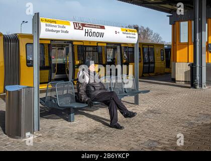 Hönow U-Bahn railway station, Eastern terminus of the U5 rail line in Berlin-Hellersdorf, Germany.  Elderly senior man sitting on platform Stock Photo