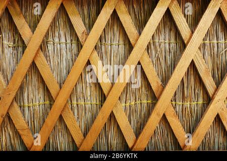 Straw fencing with longitudinal wooden partitions in Kuban style. National Kuban fence Stock Photo