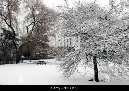 English village green in snow Stock Photo