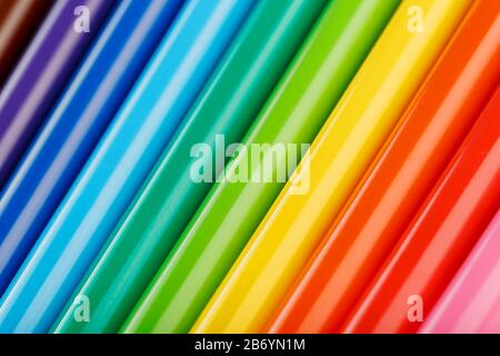 Multi-colored felt-tip pens, markers on a white isolated background, Rainbow colors close-up, macro. Stock Photo