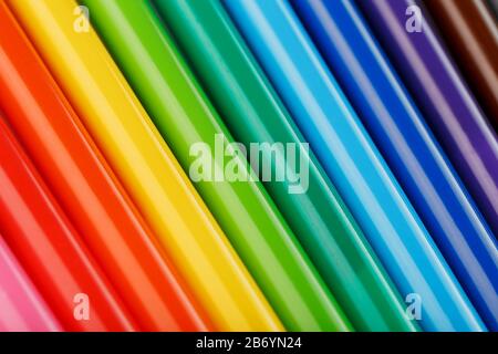 Multi-colored felt-tip pens, markers on a white isolated background, Rainbow colors close-up, macro. Stock Photo