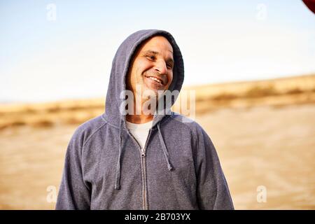 An outdoor portrait of a middle aged man.