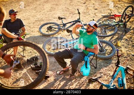 Mountain bikers enjoying post ride beers. Stock Photo
