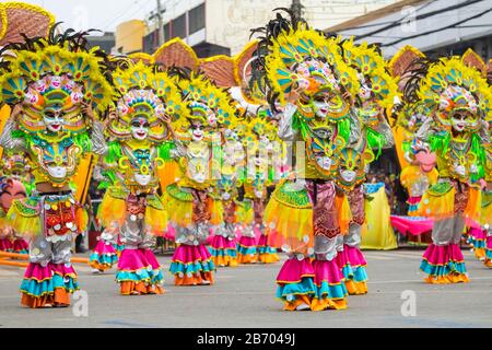 Masked dancers from Masskara Festival in Bacolod City, Negros Occidental during the 2015 Dinagyang Festival, Iloilo City, Western Visayas, Philippines Stock Photo