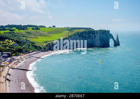 White chalk cliffs and Aiguille d'Etretat, natural stone arch on the English Channel as sunset, Etretat, Seine-Maritime department, Normandy, France Stock Photo