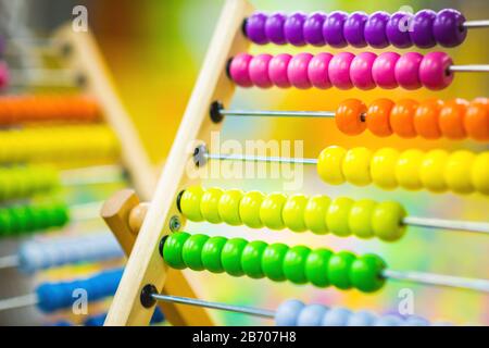 Children's wood abacus toy of bright color on the background of the playroom. Eco-friendly toys Stock Photo