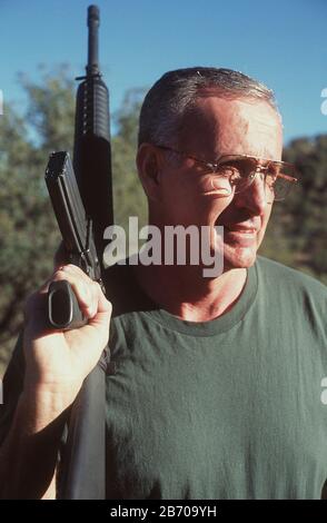 Near Fort Davis Texas USA, 1997: Republic of Texas Defense Forces member Jim (54) patrols territory considered sovereign by his group with an AR-15 semi-automatic rifle.  MR  ©Bob Daemmrich Stock Photo