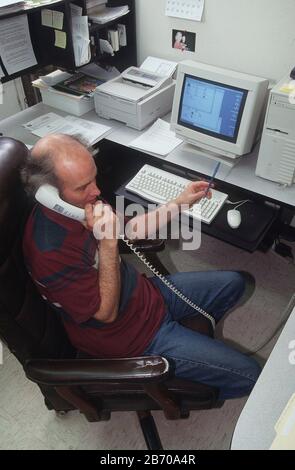 'Near Fort Davis Texas USA, 1997: Republic of Texas Chief Ambassador and Consul Richard L. McLaren sits in front of his computer and talks on the phone in his office at the separatist group's embassy.  MR  ©Bob Daemmrich Stock Photo