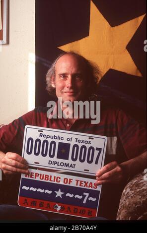 'Near Fort Davis Texas USA, 1997: Republic of Texas Chief Ambassador and Consul Richard L. McLaren, sitting at the separatist group's embassy,  holds auto license plates issued by the Republic. MR  ©Bob Daemmrich Stock Photo