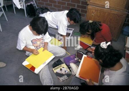 San Miguel de Allende, Guanajuato, Mexico, 1996: Fourth-grade students working on group project while sitting on floor in school classroom. ©Bob Daemmrich / Stock Photo