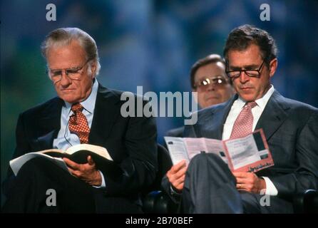 San Antonio Texas USA,1997: Evangelist Billy Graham sits on stage with Texas Gov. George W. Bush during a crusade event. ©Bob Daemmrich Stock Photo