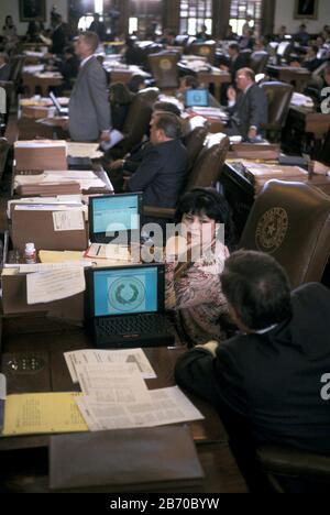 Austin, Texas USA, 1997: State Rep, Leticia Van de Putte of San Antonio with laptop computer at her desk on the floor of the Texas House of Representatives during the legislative session. ©Bob Daemmrich Stock Photo