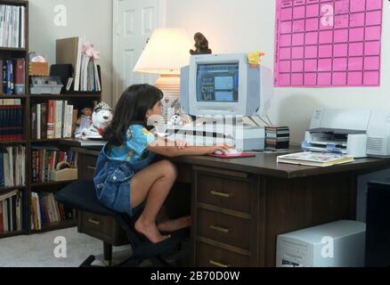 Austin Texas USA, 1997: Eight-year-old Panamanian-American girl using fun web site for learning.  MR  ©Bob Daemmrich Stock Photo