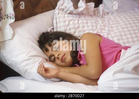 Austin, Texas USA, 1997: Eight-year-old Panamanian-American girl in bed at home sleeping.  MR  ©Bob Daemmrich Stock Photo