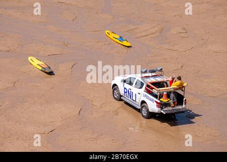 The RNLI on watch on Holywell Beach, Hollywell, north Cornwall, UK. Stock Photo