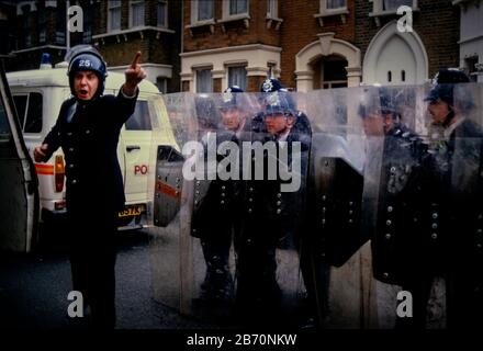 On 11 May 1985, over 2000 people participated in a militant but peaceful demonstration that was allowed to complete its route to Plashet Park. However, in a tense atmosphere, the manhandling by police of one black youth led to confrontation, the emergence of officers on horseback and riot officers who charged into the park. It appeared that this had been deliberately engineered: three to four white men in ordinary clothes were seen throwing sticks at the police; but were later seen behind police lines with police radios. Later, riot officers paraded along Green Street and East ham High Street Stock Photo