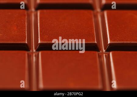 Milk chocolate close up. Segments of chocolate in the macro. Full frame texture Stock Photo