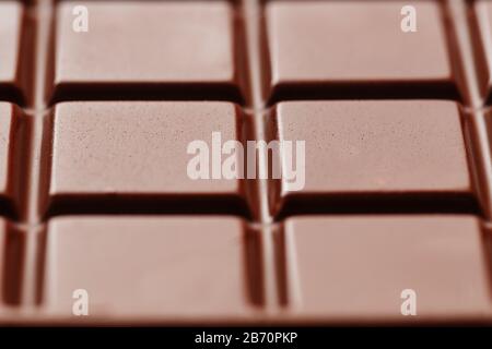 Milk chocolate close up. Segments of chocolate in the macro. Full frame texture Stock Photo