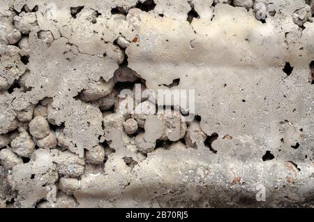 Gray concrete slab made of expanded clay concrete. A detailed shot of a concrete wall with voids. Abstract multitask background. Selective focus. Stock Photo