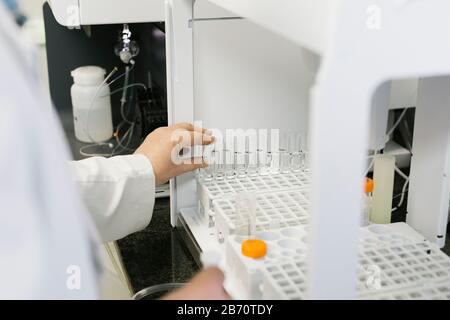 Hands of a scientist examining test tubes Stock Photo