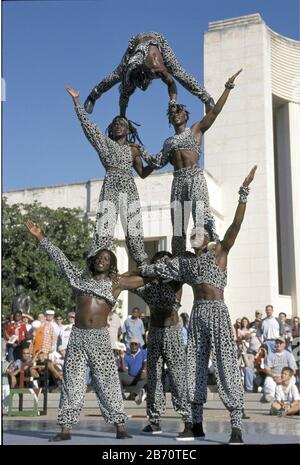 Dallas, Texas USA, October 2001: Black acrobats from Kenya performing for visitors at the State Fair of Texas.  ©Bob Daemmrich Stock Photo