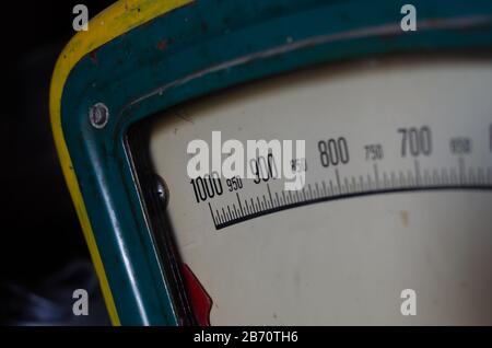 Old trade analog scales. Fragment of a metal scale with a red arrow. Digital scale with numbers. Close-up. Selective focus. Stock Photo