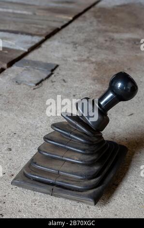 Control lever manual gearbox. Dismantled gear shift knob on the workshop floor. Car repair and maintenance. Side view. Close-up. Selective focus. Stock Photo