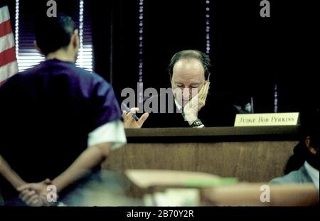 Austin Texas USA: Judge Bob Perkins on bench in 331st District Court, speaks to defendant in his courtroom.  ©Bob Daemmrich Stock Photo