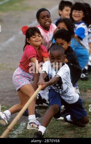 Austin Texas USA: Third-grade students compete in tug of war game during elementary school field day. Stock Photo