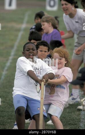 Austin Texas USA: Third-grade students compete in tug of war game during elementary school field day. Stock Photo