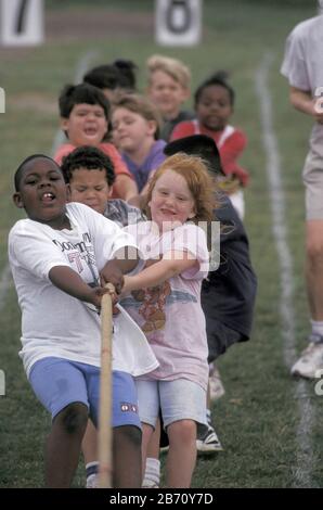 Austin Texas USA: Third-grade students compete in tug of war game during elementary school field day. Stock Photo