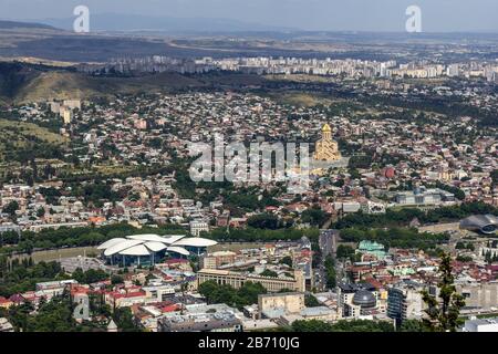 Cityscape of Tbilisi, Georgia as viewed from Mtatsminda View Point. The Holy Trinity Cathedral of Tbilisi is a prominent landmark. Stock Photo