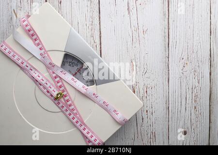Tape measure on wooden background Stock Photo - Alamy